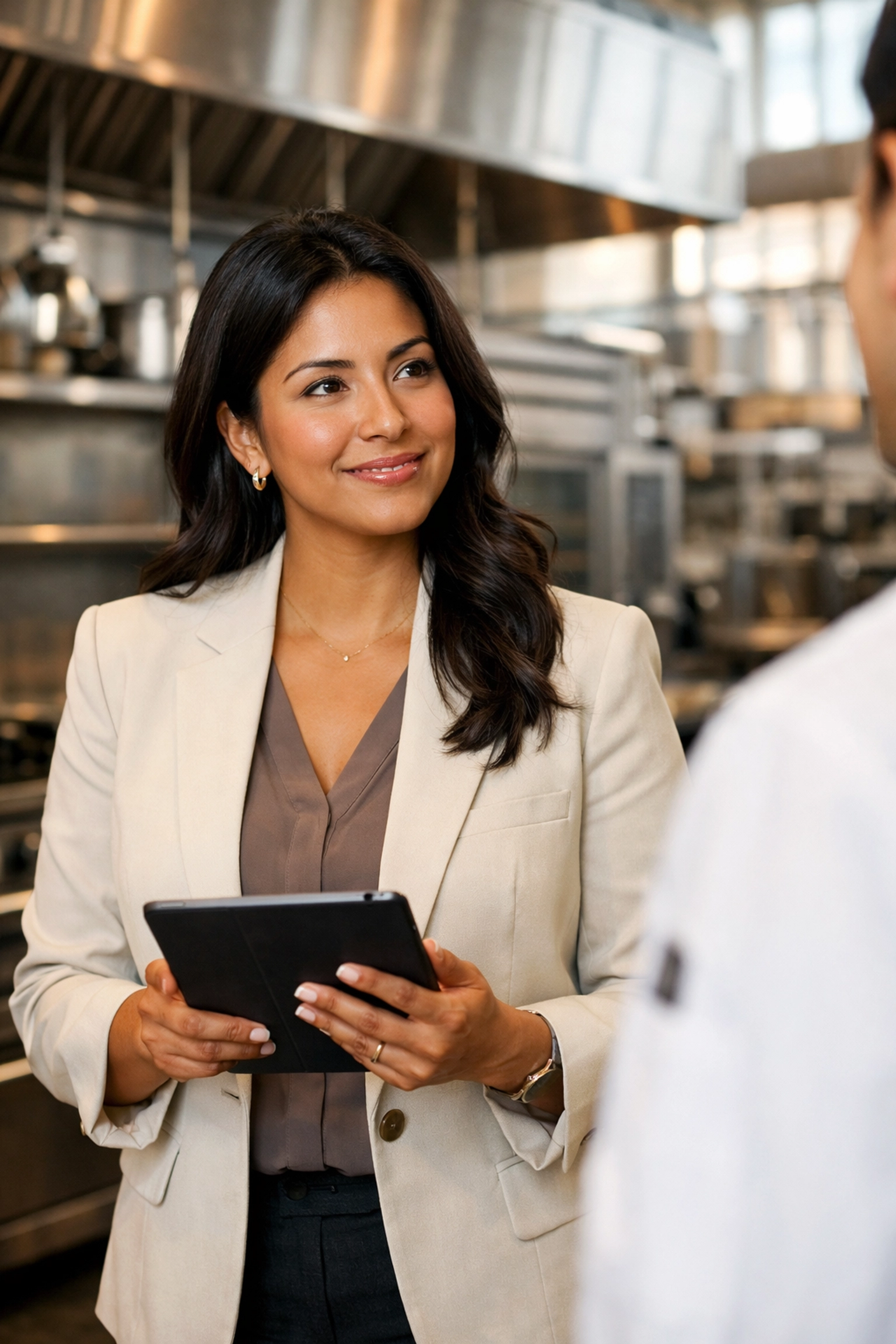Expert assessing restaurant workers comp Kentucky and equipment risks in a modern commercial kitchen.